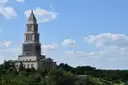 The tall George Washington Masonic National Memorial in Alexandria, Virginia, above green trees
