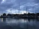 Sailboats moored in Annapolis harbor at dawn under a cloudy sky