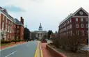 A brick street in Annapolis, Maryland, with a domed building at its far end.