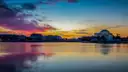 Jefferson Memorial across the calm Tidal Basin under a pink and orange sky