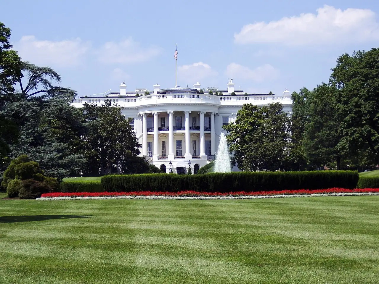 White House south portico with fountain and red flower beds beyond the South Lawn