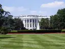 White House south portico with fountain and red flower beds beyond the South Lawn