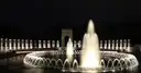 World War II Memorial at night with lit fountain, ring of pillars and the Pacific arch