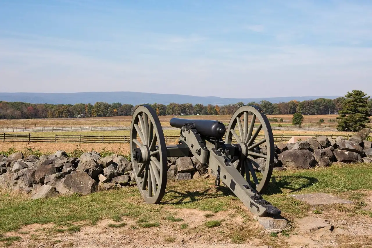 A Civil War cannon beside a stone wall on the Gettysburg battlefield
