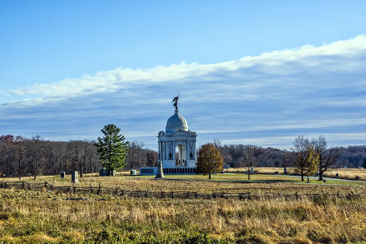 The Pennsylvania State Memorial on the Gettysburg battlefield, seen across a field with a rail fence