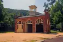 The brick fire engine house at Harpers Ferry, West Virginia, among trees.