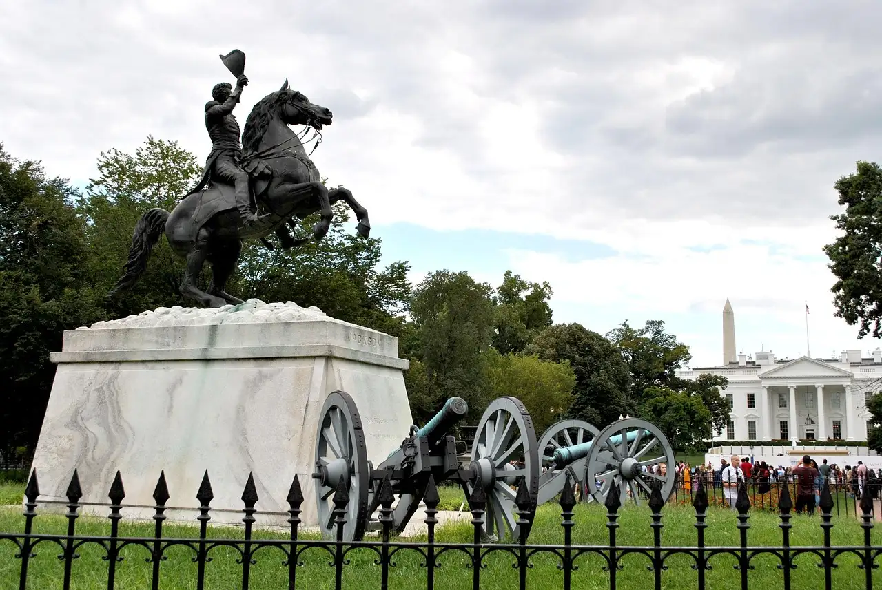 The bronze statue of Andrew Jackson on horseback in Lafayette Square, with the White House behind the trees