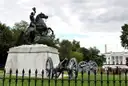 The bronze statue of Andrew Jackson on horseback in Lafayette Square, with the White House behind the trees