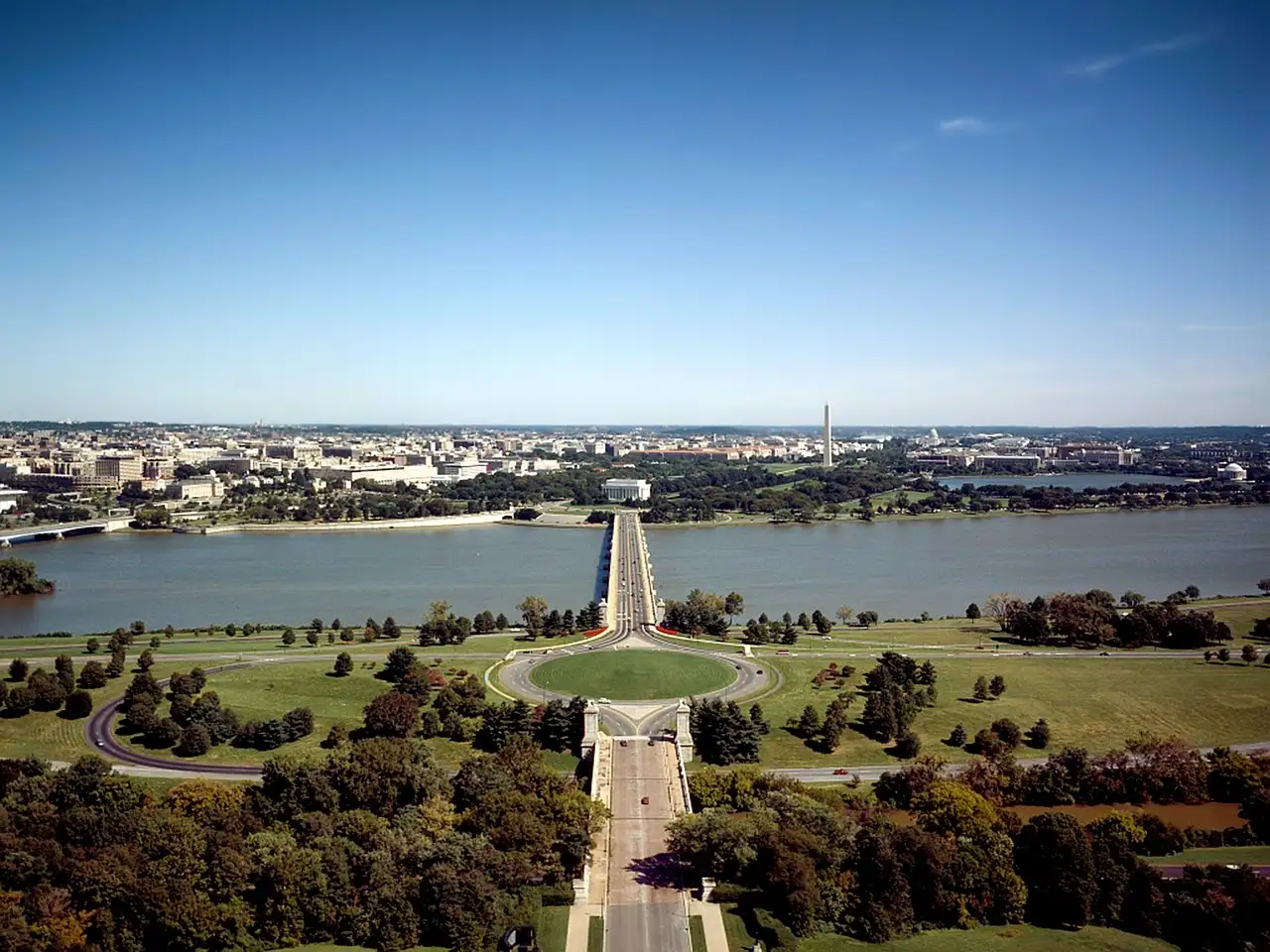 The Potomac River from above, with Arlington Memorial Bridge leading across the water to the Lincoln Memorial and the city