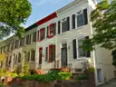 Painted brick row houses with shutters and small front gardens in Foggy Bottom, Washington, DC