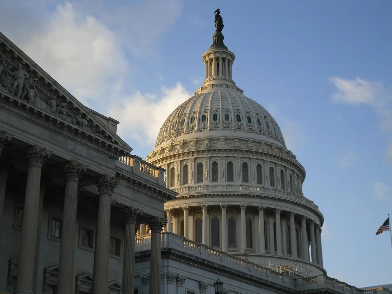 The dome and one wing of the US Capitol in Washington, DC, in warm afternoon light.
