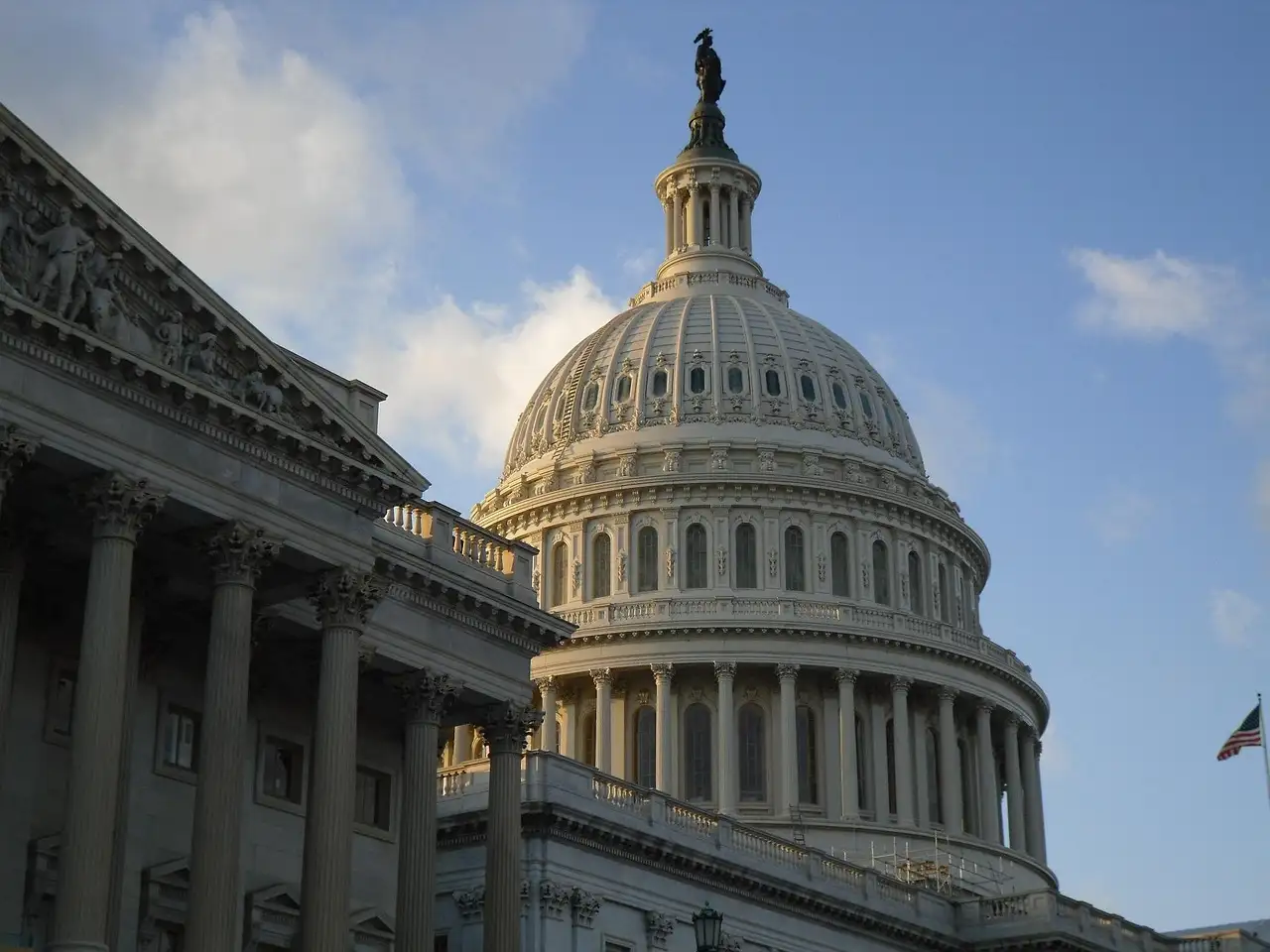 The dome and one wing of the US Capitol in Washington, DC, in warm afternoon light.