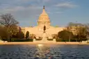 The US Capitol in evening light behind the Capitol Reflecting Pool