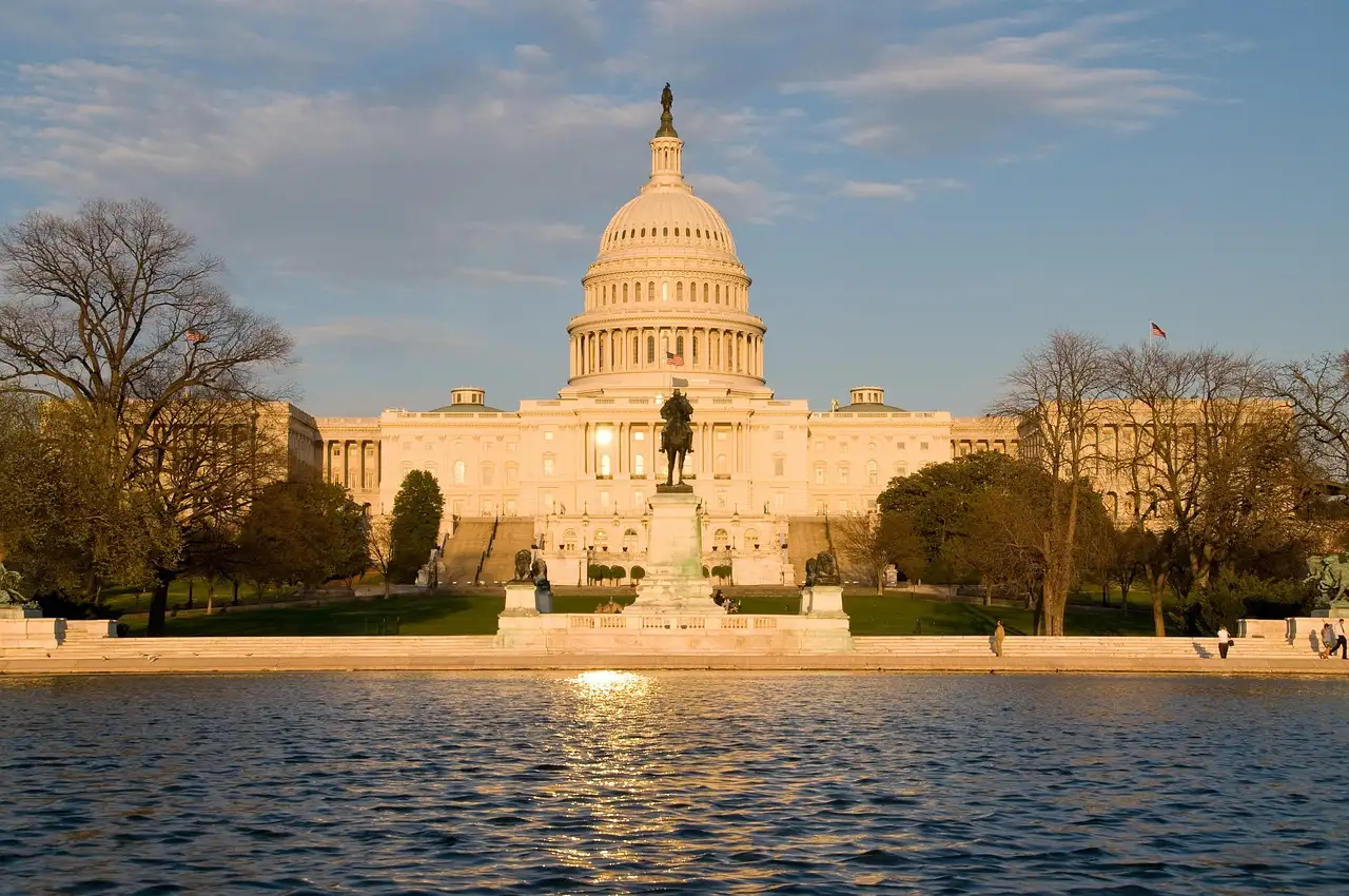 The US Capitol in evening light behind the Capitol Reflecting Pool