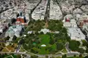 Aerial view of the White House and its lawns among downtown Washington, DC streets