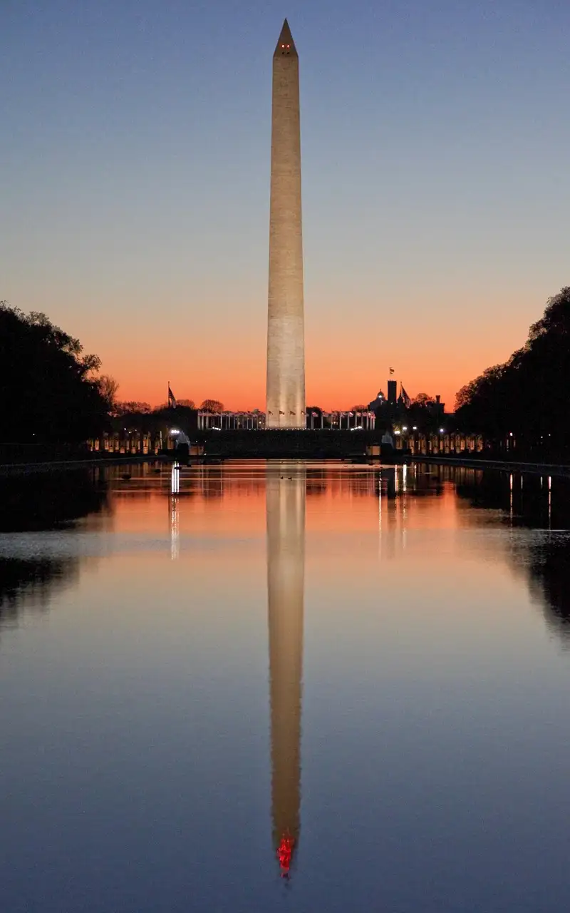 The Washington Monument at dawn, reflected in the Lincoln Memorial Reflecting Pool on the National Mall