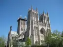 The Gothic towers of Washington National Cathedral under a blue sky